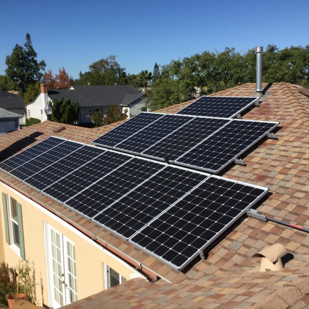 A couple of solar panels on the side of a house.